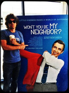 Gooding in front of the Won't You Be My Neighbor? film poster