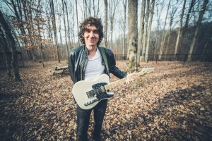 Gooding with guitar in the woods